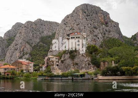 Splendida vista delle montagne che circondano la città di Omis, Croazia, con un bellissimo paesaggio che unisce vette rocciose e vegetazione lussureggiante. Foto Stock