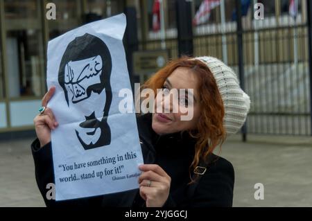 Londra, Regno Unito. 13 gennaio 2018. Un manifestante presso l'ambasciata degli Stati Uniti a Grosvenor Square tiene in mano cartelli con bambole bendate maschili e femminili che rappresentano bambini detenuti che chiedono aiuto. La protesta ha chiesto il rilascio di tutti i bambini detenuti nelle carceri israeliane, tra cui Ahed Tamimi, trattenuti per schiaffo un soldato israeliano che è entrato nel giardino della sua famiglia poco dopo aver saputo che un parente era stato ucciso dalle forze israeliane. E' una delle migliaia di bambini palestinesi detenuti da Israele dal 2000 in una politica sistematica che, secondo le Nazioni Unite, comprende abusi e malattie Foto Stock