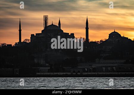 Splendido tramonto alla sagoma del minareto della moschea del Bosforo, barche sull'acqua nella zona Sultanahmet di Istanbul in Turchia Foto Stock