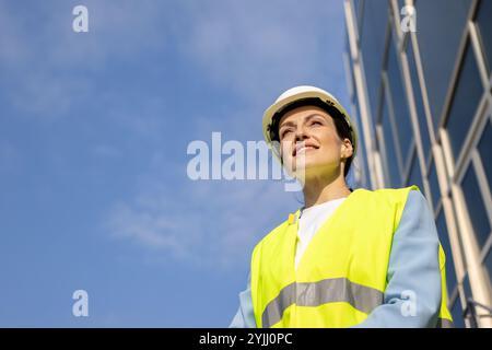 Ritratto di un operaio edile felice in un giubbotto di sicurezza. Copia spazio. Foto Stock