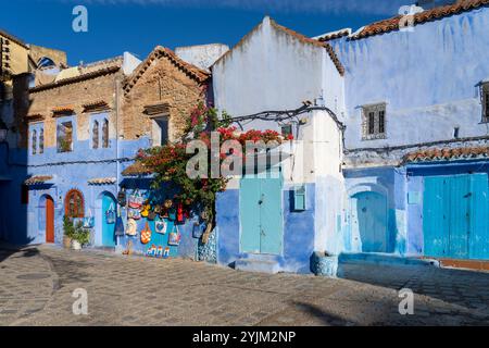 Chefchaouen, Marocco - 23 ottobre 2024: Case e strade di colore blu con souvenir turistici esposti in vendita a Chefchaouen, Marocco. Foto Stock