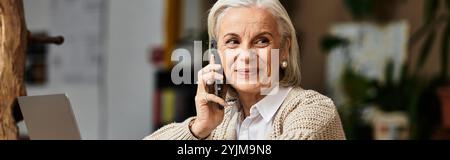 Questa donna affascinante gode di una conversazione allegra, irradiando calore e felicità in casa. Foto Stock