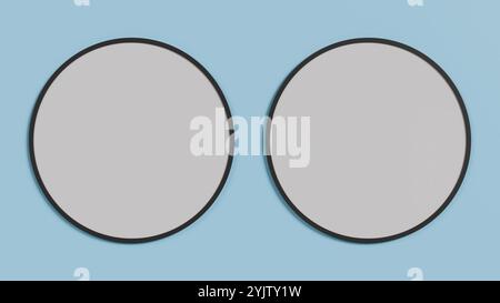 Due telai rotondi vuoti su una parete blu. Design minimalista e moderno, perfetto per progetti di interior design e come ispirazione per la decorazione. Foto Stock