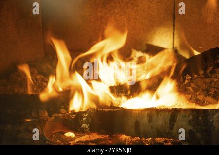 Legna da ardere sta bruciando nel forno del primo piano del focolare. Riscaldamento ecologico alternativo, camera calda e accogliente a casa, legna da ardere Foto Stock