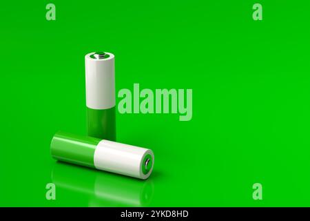 Due batterie cilindriche posizionate su una superficie verde riflettente, che simboleggiano le energie rinnovabili e le soluzioni energetiche sostenibili. Rendering 3D. Foto Stock