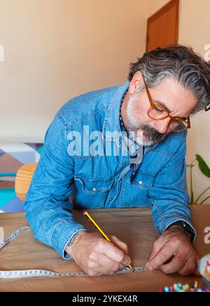 Ritratto di un uomo di mezza età che disegna uno schema a casa Foto Stock