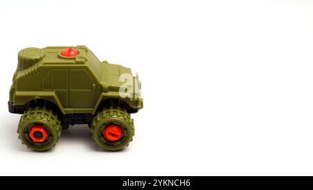 Giocattolo per bambini a forma di Jeep militare con sfondo bianco, fotografato con Una composizione che lascia spazio sul lato destro Foto Stock