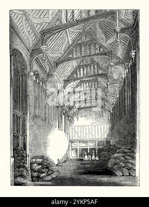 Una vecchia incisione dell'interno della Great Hall a Eltham Palace, Eltham, Greenwich, se Londra, Kent, Inghilterra, Regno Unito c.1700, quando gran parte della terra circostante fu affittata e la sala utilizzata per immagazzinare il fieno, è tratta da un libro di storia vittoriana. Il palazzo originale fu dato a Edoardo II nel 1305 e utilizzato come residenza reale dal XIV al XVI secolo. Con la grande ricostruzione di Greenwich Palace, Eltham fu lasciata in uno stato fatiscente. La Great Hall vanta il terzo tetto a martelletto più grande d'Inghilterra. Foto Stock