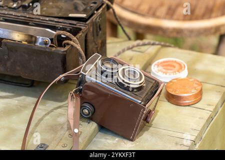 Vecchia fotocamera reflex a doppio obiettivo su un tavolo in legno Foto Stock