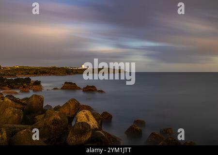Il faro di Ponta da Ilha a Manhenha, l'isola di Pico, nelle Azzorre, è situato vicino a una vasta costa di lava. Foto Stock