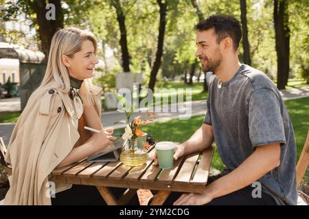 Giovane coppia che si gode una pausa caffè nel parco Foto Stock