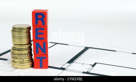 Scrittura AFFITTO investimenti immobiliari. Concetto di gestione della ricchezza finanziaria costruzione di disegni con monete in euro. Foto Stock