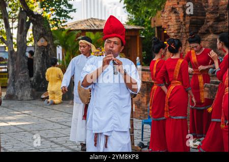 Musicista maschile vietnamita che suona una pipa in una celebrazione al po Nagar Cham Towers a Nha Trang in Asia. Nha Trang, Vietnam - 8 agosto 2024 Foto Stock