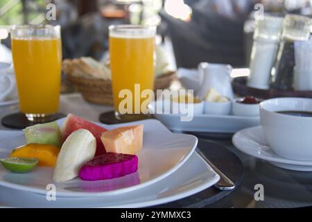 colazione tropicale con assortimento di frutta, caffè e succo d'arancia Foto Stock
