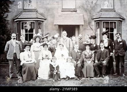 Una fotografia di matrimonio del 1920 circa, ma non datata. La fotografia mostra un gruppo, tra cui la sposa e lo sposo, in piedi e seduti fuori casa. La fotografia originale era della Redhill Photo Co di Station Road, Redhill, Surrey. Foto Stock