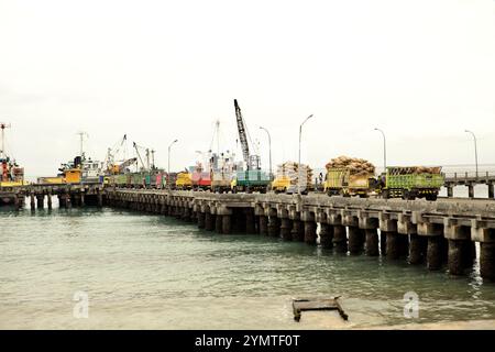 Camion da carico in fila sul molo per far scendere il carico al porto di Waikelo a Tambolaka, Sumba sud-occidentale, Nusa Tenggara orientale, Indonesia. Foto Stock