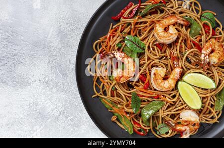 Spaghetti udon fritti con gamberi e verdure, cucina asiatica, fatti in casa, niente persone Foto Stock