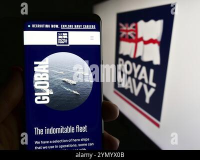 Stoccarda, Germania, 03-25-2024: Persona con smartphone con pagina web della guerra navale britannica Royal Navy (RN) davanti al logo. Concentratevi sul cen Foto Stock