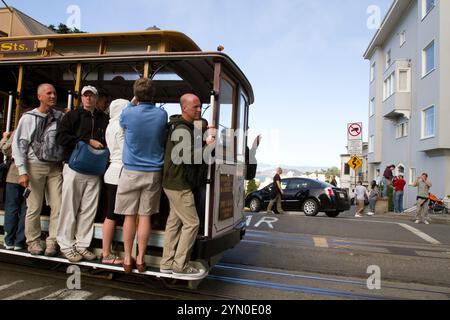 Ciclisti sulle famose funivie di San Francisco. Foto Stock