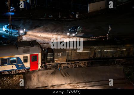 Sfax, Tunisia - 11 novembre 2024: Treno all'incrocio con la strada. Foto Stock