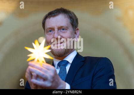 Dresda, Germania. 25 novembre 2024. La Herrnhuter Sterne GmbH e la Stiftung Frauenkirche Dresden presentano congiuntamente la Herrnhuter Edition "Frauenkirche Dresden" e consegnano la prima stella al Ministro Presidente del libero Stato di Sassonia, Michael Kretschmer. In occasione dei 20 anni di collaborazione tra la Frauenkirche Dresden Foundation e la Herrnhuter Sterne GmbH, è stata creata un'edizione "Frauenkirche Dresden" nella combinazione di colori giallo/bianco. Credito: Jürgen Lösel/dpa-Zentralbild/dpa/Alamy Live News Foto Stock