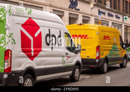 LONDRA - 21 NOVEMBRE 2024: I furgoni DPD e DHL per la consegna tramite corriere sono parcheggiati nella via centrale di Londra Foto Stock