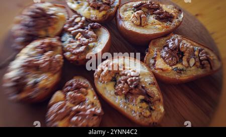Pere cotte con noci e formaggio blu, che catturano un'atmosfera rustica e confortevole. Foto Stock