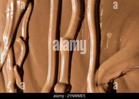 Vista dall'alto del cioccolato al latte fuso, consistenza del cioccolato. Foto Stock