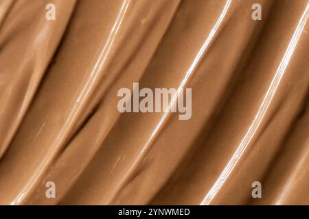 Vista dall'alto del cioccolato al latte fuso, consistenza del cioccolato. Foto Stock