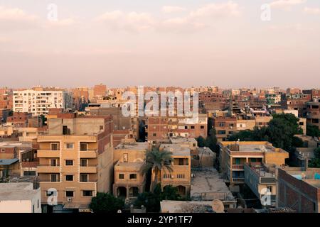 Vista aerea del Cairo con case in mattoni rossi dal complesso piramidale di Giza, la necropoli di Giza, sull'altopiano di Giza nel grande Cairo, in Egitto Foto Stock