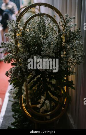 Decorazioni per matrimoni con una splendida disposizione di fiori ed elementi metallici circolari, che creano un'atmosfera elegante e romantica. Perfetto per Foto Stock