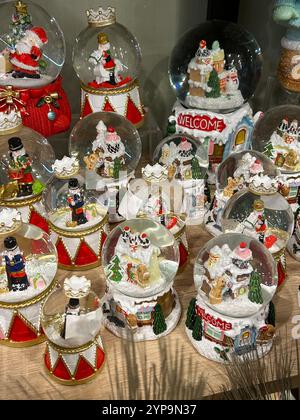 Questa foto orizzontale cattura una collezione di globi da neve splendidamente lavorati, ognuno dei quali ritrae scene invernali uniche e festose. Racchiuso in scintillanti Foto Stock