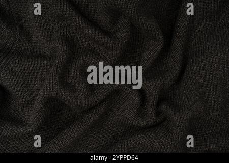 Maglia grigio scuro come sfondo. Modello a maglia. Vista dall'alto. Foto Stock