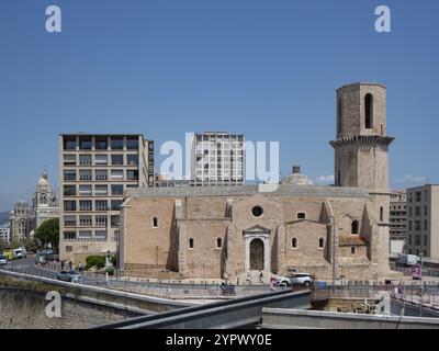 Eglise St.-Laurent è una chiesa romana all'ingresso del vecchio porto di Marsiglia, in Francia. Facciata della chiesa circondata da edifici moderni Foto Stock