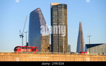 London, UK. People and a red London bus crossing Waterloo Bridge in front of One Blackfriars (The Vase / The Boomerang) the ITV Tower and the Shard (l Foto Stock