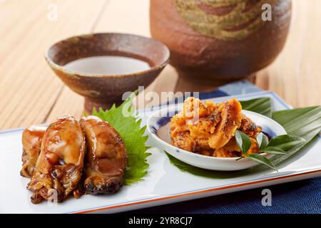 Teriyaki di ostriche e ricci di mare grigliati Foto Stock