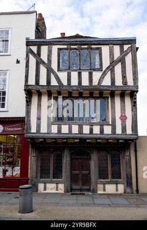 8 Palace Street è una delle case in legno più fotografate di Canterbury, con caratteristiche esterne sorprendenti. Fu costruita intorno al 1250 come casa del prete per la vicina chiesa di Sant'Alfago, con una sala al primo piano sopra un sottotetto in pietra. Le cornici in legno e la sporgenza del primo piano furono aggiunte alla fine del XV secolo, seguite da grandi estensioni nel 1665 con l'aggiunta del secondo piano e di un nuovo edificio tra l'attuale struttura e la chiesa. Canterbury è una città e patrimonio dell'umanità dell'UNESCO, nella contea del Kent, in Inghilterra; è stato un borough di contea fino al 1974 Foto Stock