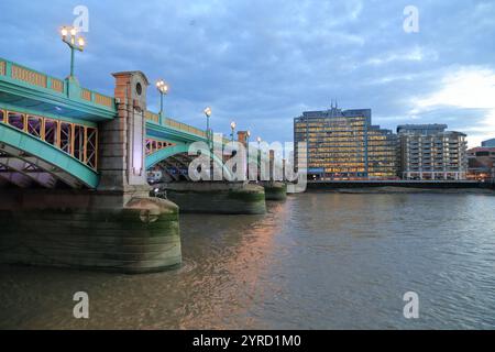 Vista panoramica dello skyline di Londra con gli edifici iconici del centro della città, il Tamigi e un ponte che attraversa l'acqua al tramonto. Foto Stock