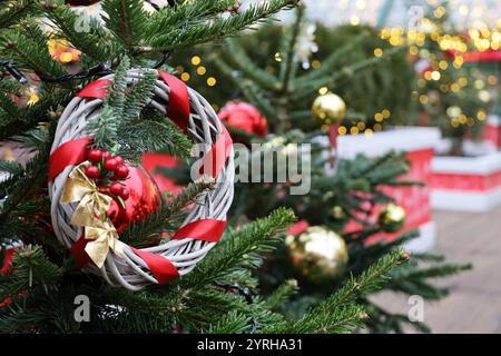 Festa di Capodanno, rami dell'albero di Natale con palle giocattolo sullo sfondo di luci dorate Foto Stock