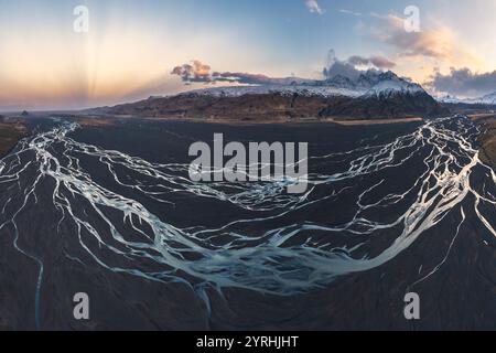 Splendido panorama aereo della Valle di Thorsmork in Islanda, caratterizzato da intricati fiumi intrecciati che scorrono tra aspri paesaggi vulcanici e innevati Foto Stock