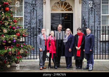 Londra, Regno Unito. 4 dicembre 2024. L'ex portiere inglese David Seaman, con sua moglie Frankie (in cappotto rosso) e rappresentanti dell'ente di beneficenza, presenta una petizione al 10 di Downing Street per la British Heart Foundation. Seaman è un ambasciatore di celebrità per la British Heart Foundation e in passato gli è stata diagnosticata una fibrillazione atriale (battito cardiaco irregolare). Crediti: Imageplotter/Alamy Live News Foto Stock