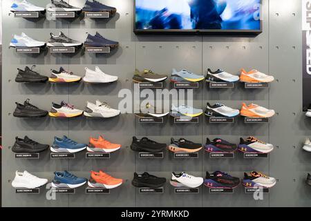 KUALA LUMPUR, MALESIA - 1 DICEMBRE 2023: Calzature esposte al negozio Under Armour nel centro commerciale Suria KLCC. Under Armour è un marchio globale Foto Stock