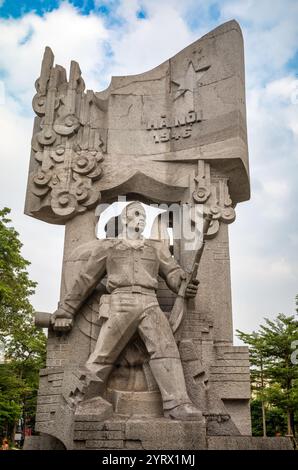 La parte posteriore della statua socialista realista che commemora la giornata della resistenza nazionale del 1946 contro il dominio coloniale francese nel giardino dei fiori di Van Xuan a Cent Foto Stock