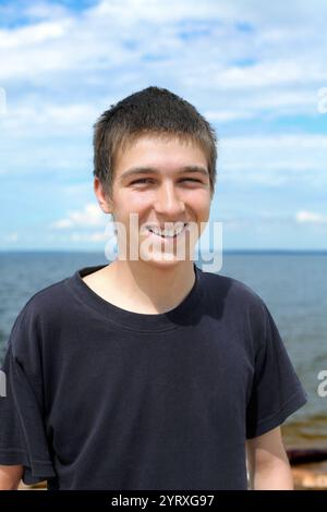 felice ritratto di un giovane uomo sul mare Foto Stock