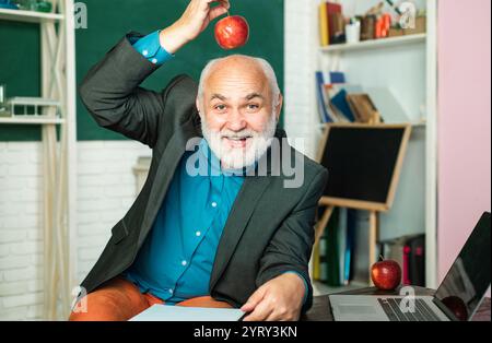 Giornata mondiale degli insegnanti. Professore in classe sulla lavagna. Tutoraggio. Insegnante barbuta vicino alla lavagna in classe scolastica Foto Stock