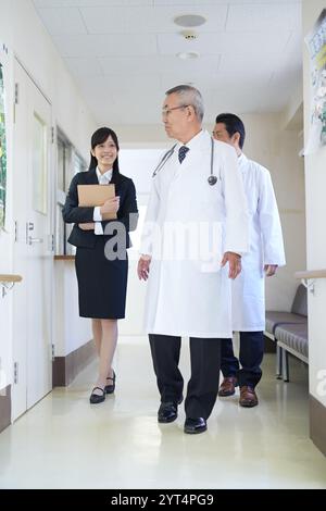 Personale medico che cammina lungo il corridoio Foto Stock