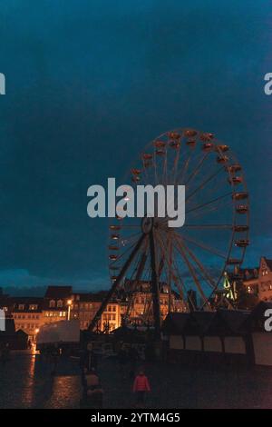 Ruota panoramica illuminata di notte di fronte alla cattedrale di Erfurt con luci calde e cielo notturno buio. Foto di alta qualità Foto Stock