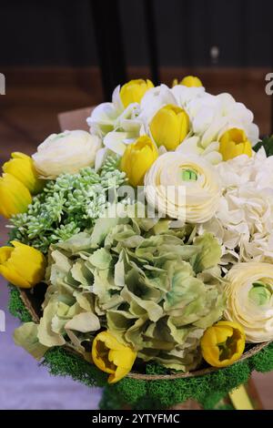 Una splendida e splendida disposizione floreale con accenti giallo brillante e verde Foto Stock