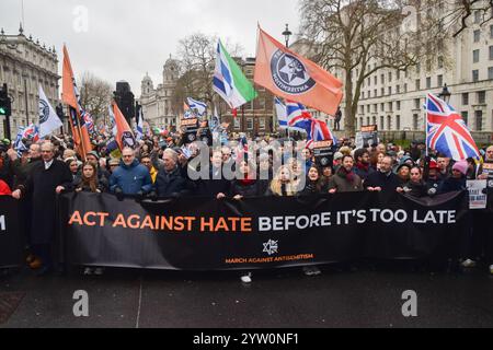 Londra, Regno Unito. 8 dicembre 2024. I manifestanti marciano con uno striscione che recita "agire contro l'odio prima che sia troppo tardi" durante la manifestazione a Whitehall. Migliaia di persone hanno marciato nel centro di Londra contro l'antisemitismo e a sostegno di Israele mentre Israele continua i suoi attacchi a Gaza. Credito: SOPA Images Limited/Alamy Live News Foto Stock