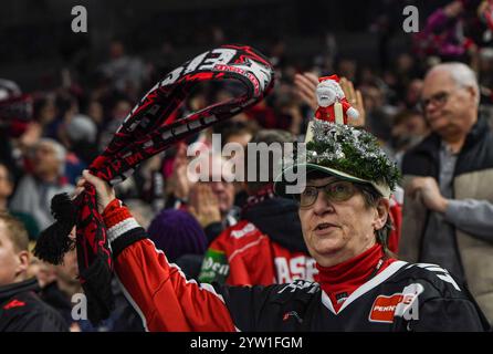 Colonia, Renania settentrionale-Vestfalia, Germania. 8 dicembre 2024. Un fan di Koelner Haie che indossa un cappello con uno squalo in un abito di Babbo Natale celebra il primo gol di Koelner Haie nella partita 24 della Deutsche Eishockey Liga (German Ice Hockey League) tra il Koelner Haie (Cologne Sharks) e l'Augsburger Panther nella Lanxess Arena di Colonia, Germania, l'8 dicembre 2024. (Credit Image: © Kai Dambach/ZUMA Press Wire) SOLO PER USO EDITORIALE! Non per USO commerciale! Foto Stock